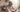 At lunchtime, an older man wearing CaptionLens Live Caption Glasses sits at the dining table, talking with a young boy.