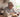 At lunchtime, an older man wearing CaptionLens Live Caption Glasses sits at the dining table, talking with a young boy.