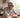 At lunchtime, an older man wearing CaptionLens Live Caption Glasses sits at the dining table, talking with a young boy.